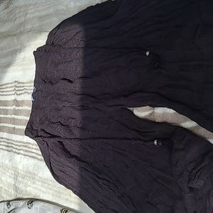 Black beach pants with slits through the legs.